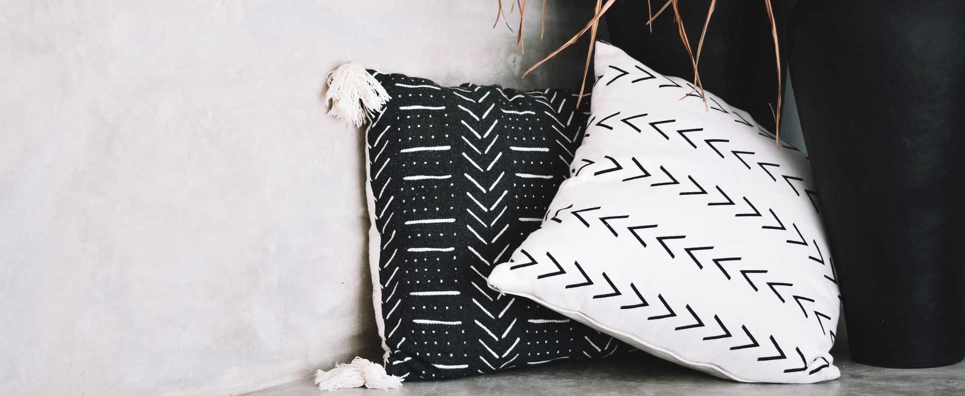 Stripete Zig Zag puter i varme farger, arrangert på en sofa